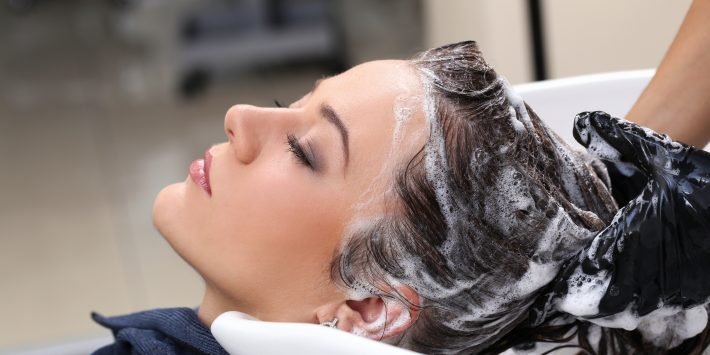 Hairdresser salon. Woman during hair wash