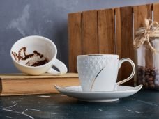 A cup of coffee with an empty one aside